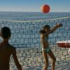 Bambini giocano a pallavolo sulla spiaggia.