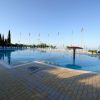 Piscina all'aperto con bandiere e sedie a sdraio.