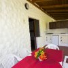 Veranda con tavolo e sedie bianche, cucina all'aperto.