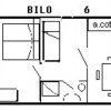 Piantina di un bilocale con cucina e area soggiorno.