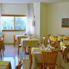 Sala da pranzo con tavoli apparecchiati.
